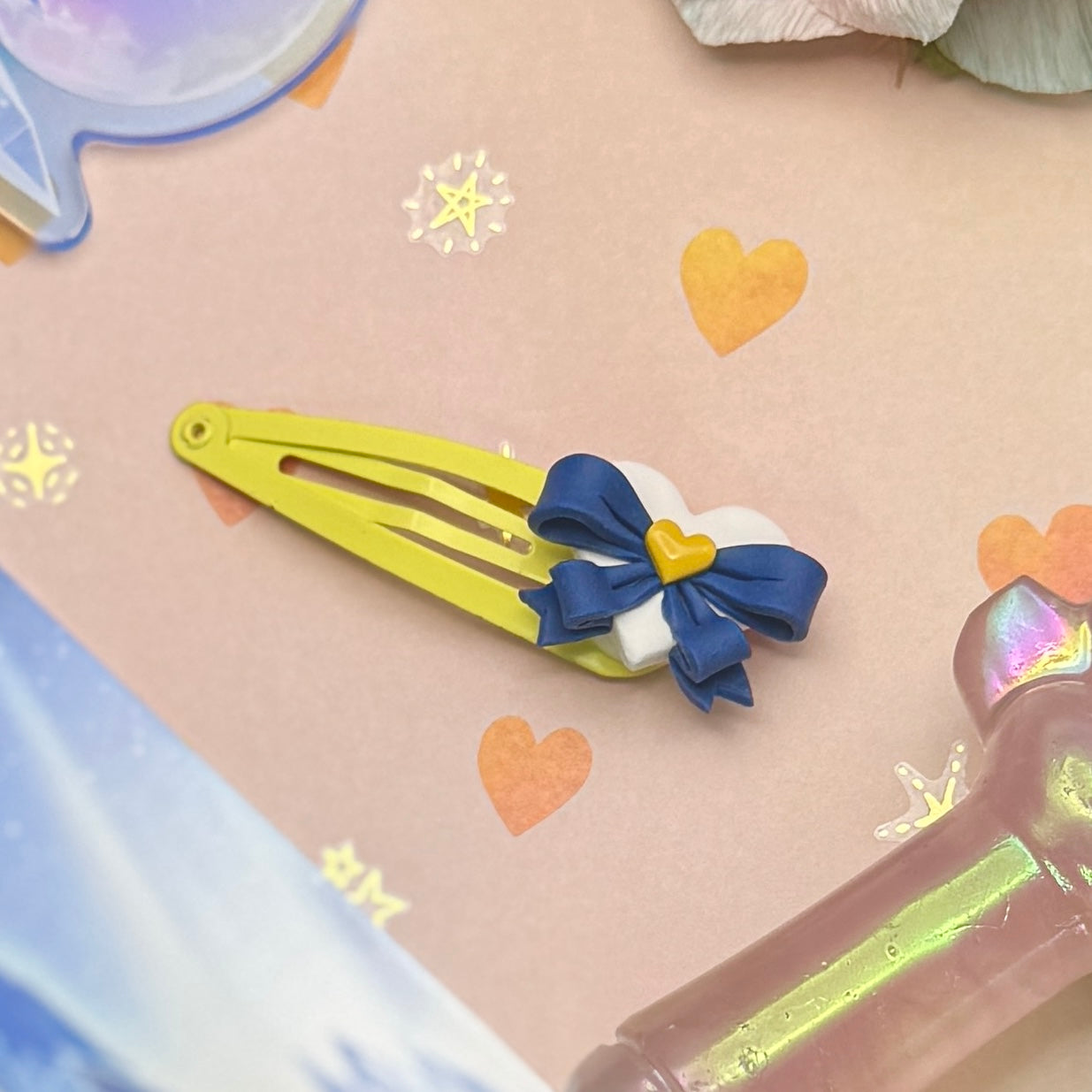 Yellow hair clip with a blue bow on a decorative background