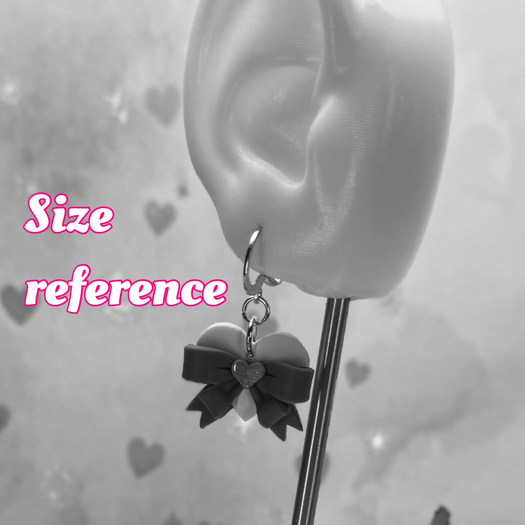 Earring displayed on an ear with 'Size reference' text in pink.